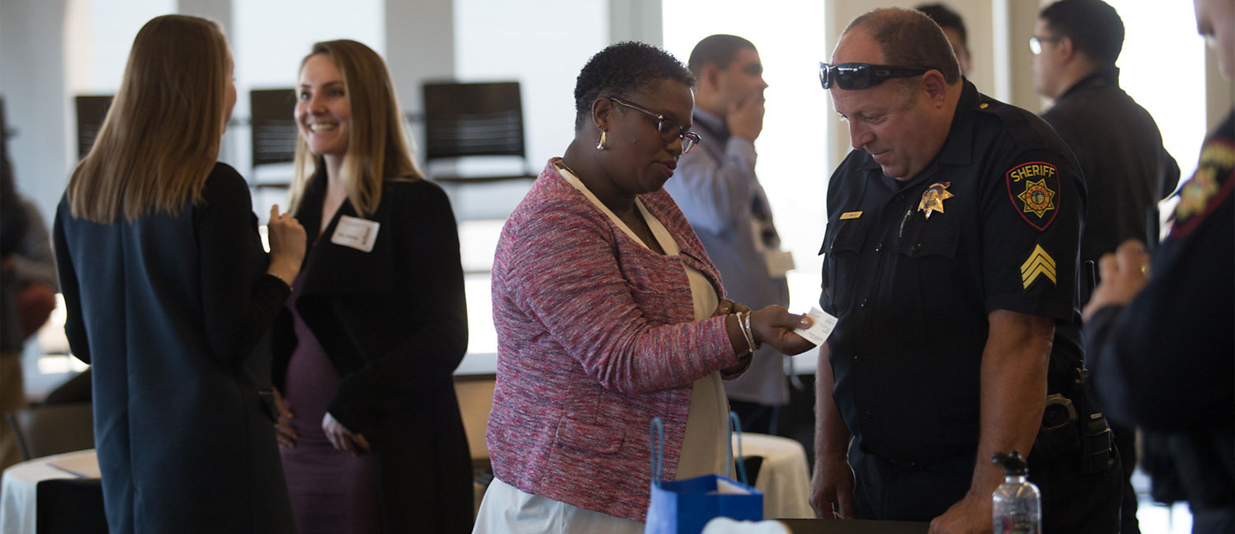 Woman speaks with police officer at event