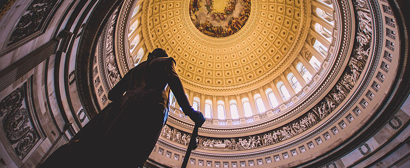 Image of statue inside of court building with golden ceiling